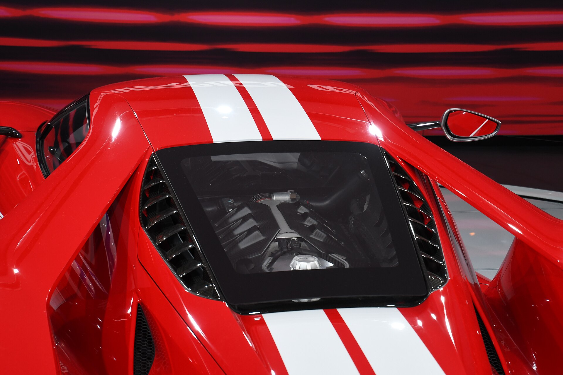 The EcoBoost V6 visible through the GT's rear hatch glass, buttresses sweeping past on both sides